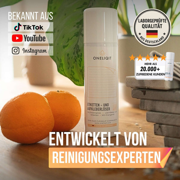 Etikettenlöser Etikettenentferner Spray 200ml mit Orangenöl neben frischen Orangen auf einem Tisch.
